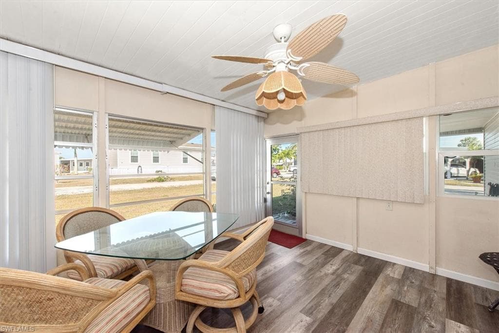 Dining room with wood finished floors and ceiling fan