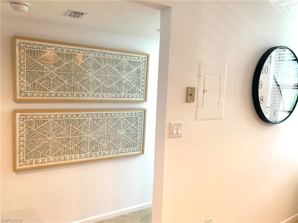 Detailed view of electric panel and baseboards