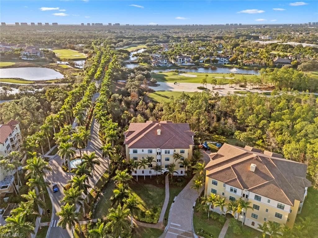 Drone / aerial view of a nearby body of water and a golf course
