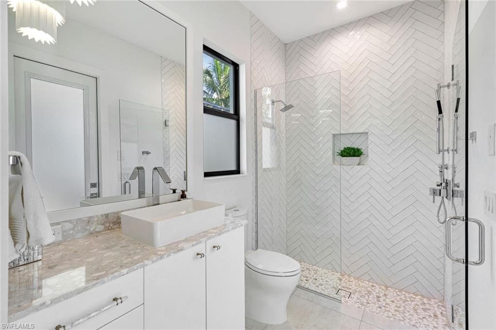 Bathroom featuring vanity, a stall shower, and light tile patterned floors