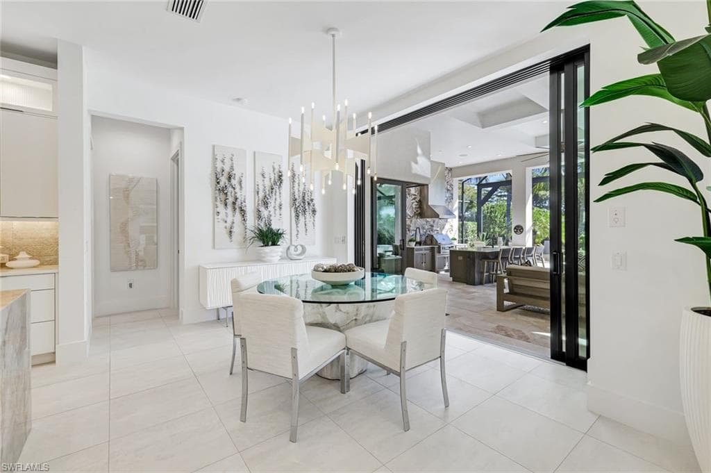 Dining area with a chandelier and light tile patterned flooring