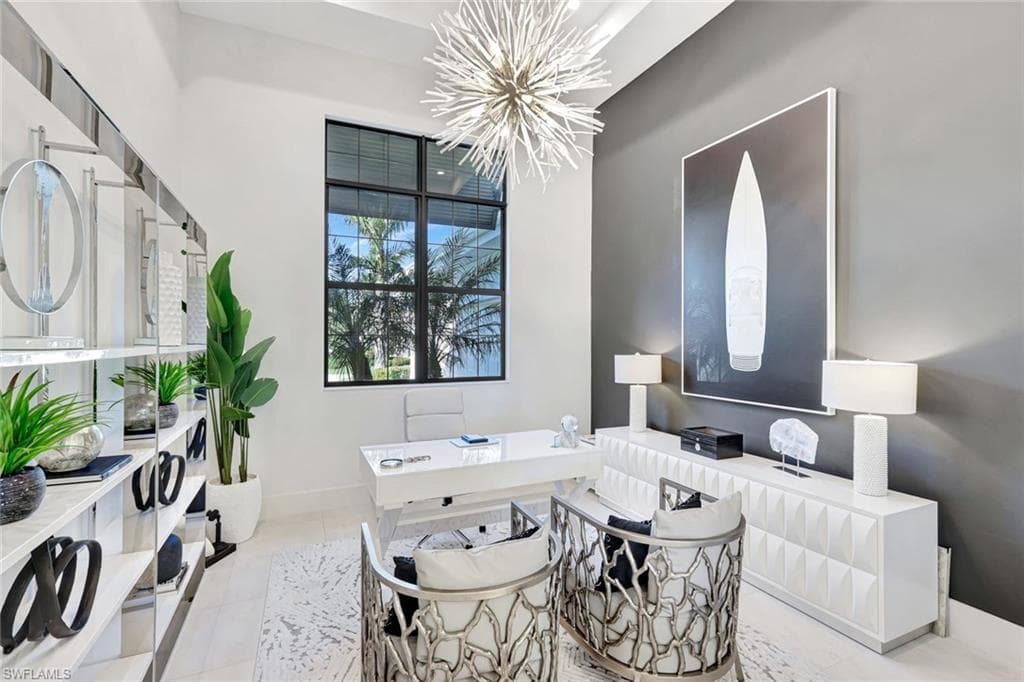 Tiled home office with a chandelier and baseboards
