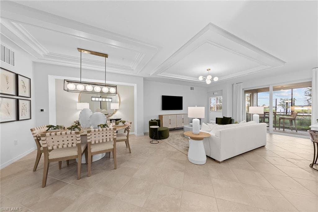 Living area with a chandelier and a raised ceiling