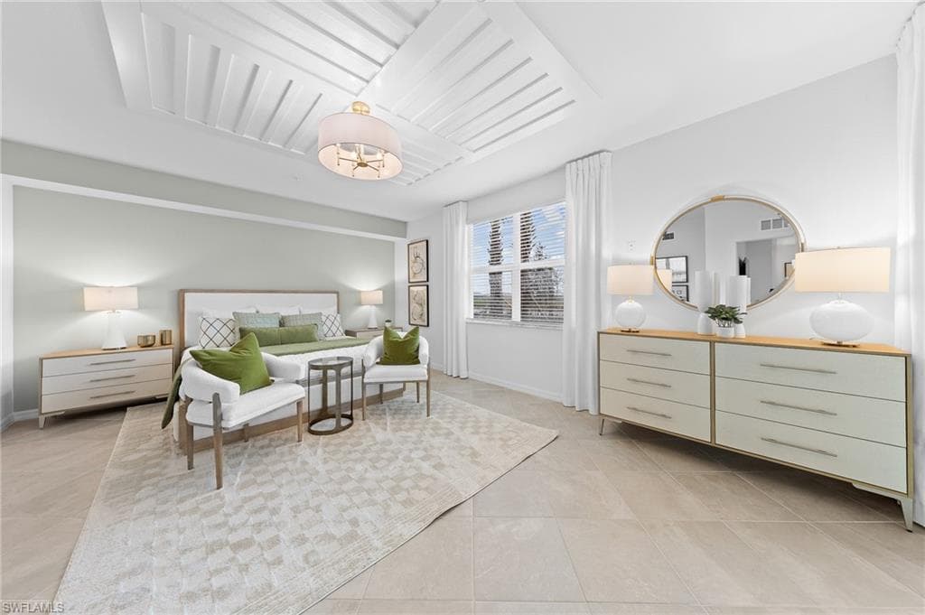 Bedroom with baseboards and light tile patterned flooring