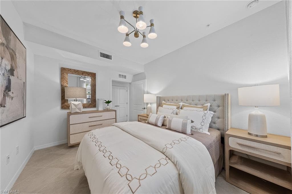 Bedroom featuring a chandelier and light tile patterned floors