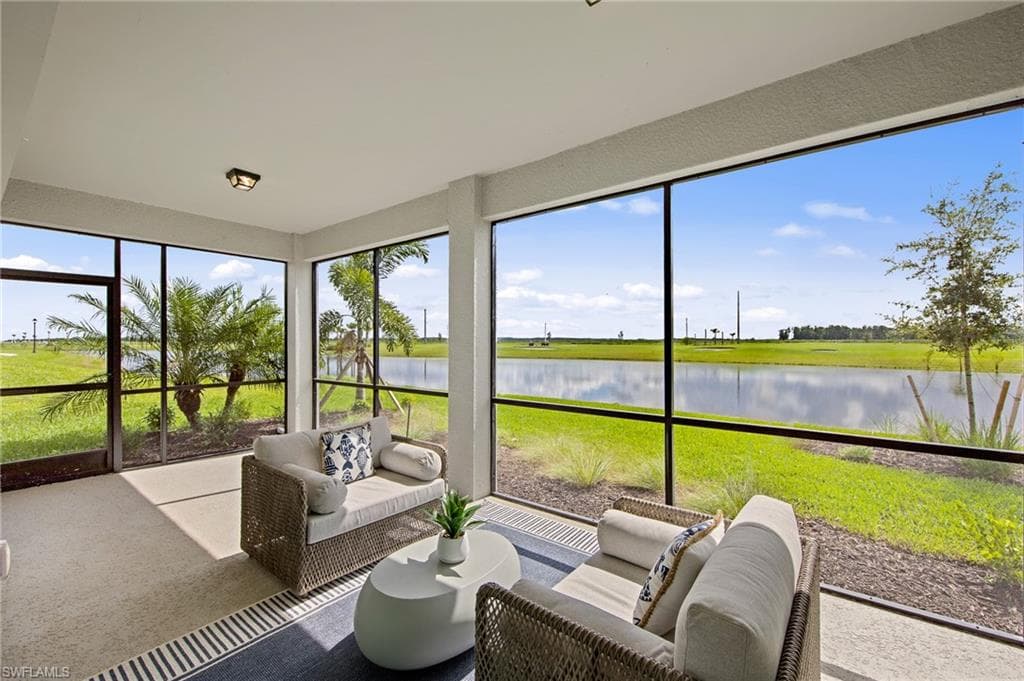 Sunroom / solarium featuring an outdoor living space and a water view