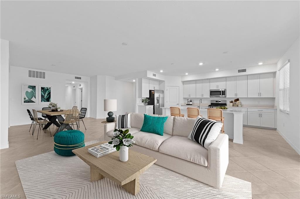 Living area with recessed lighting and light tile patterned flooring