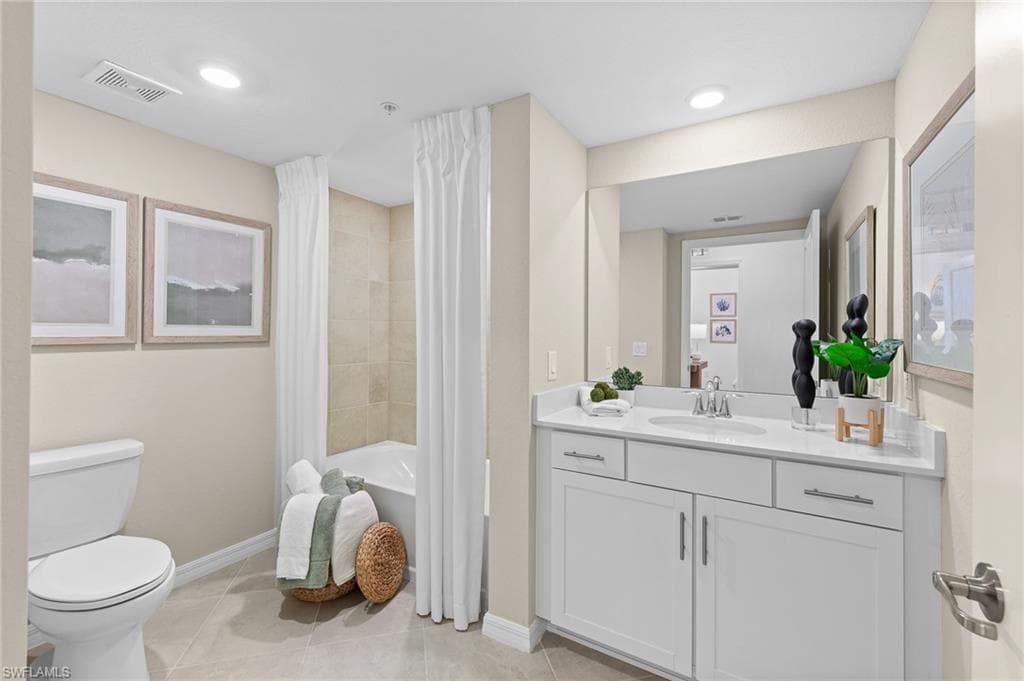 Bathroom featuring light tile patterned floors, vanity, shower / bathtub combination with curtain, and recessed lighting