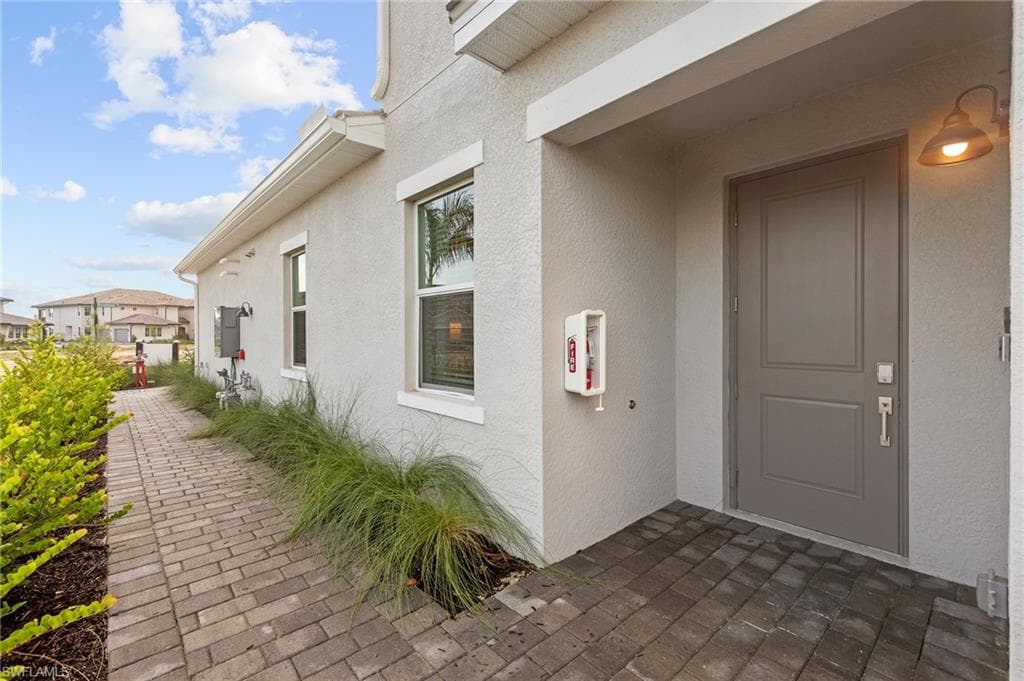 Property entrance featuring stucco siding