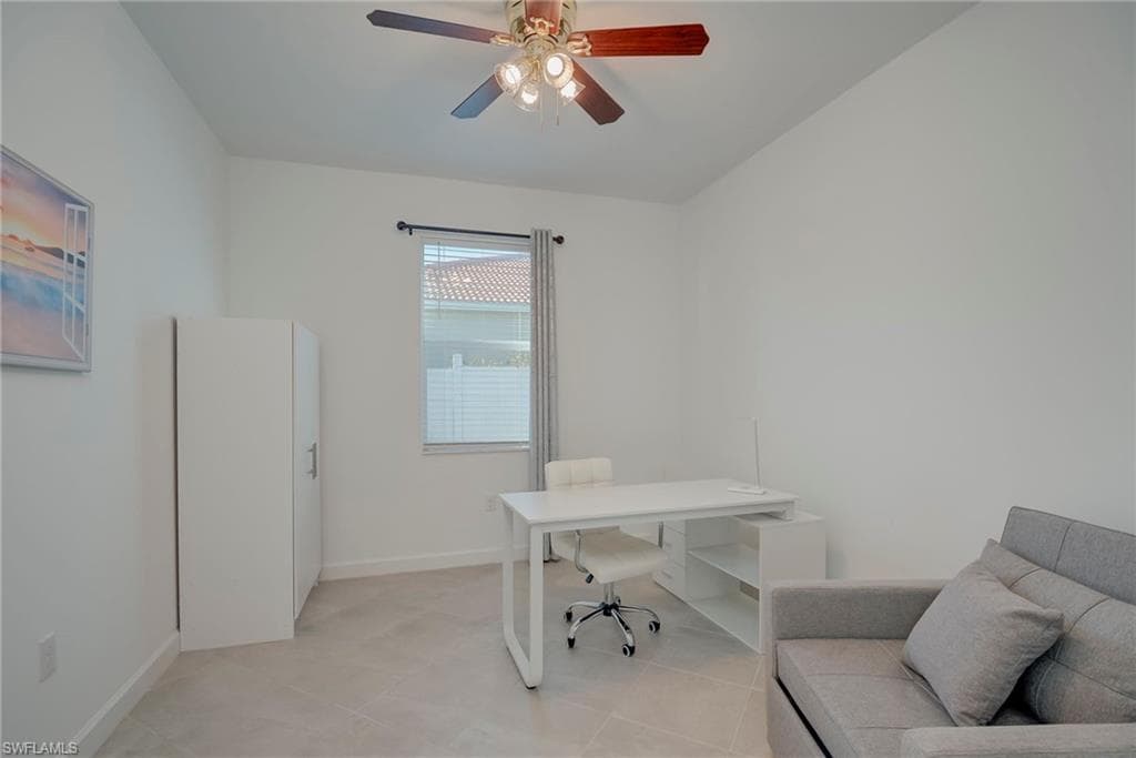 Home office featuring baseboards and ceiling fan
