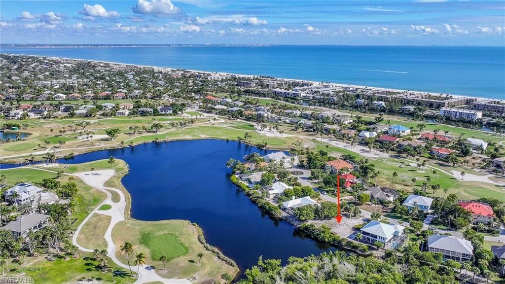 Aerial perspective of suburban area with a local golf course and a nearby body of water