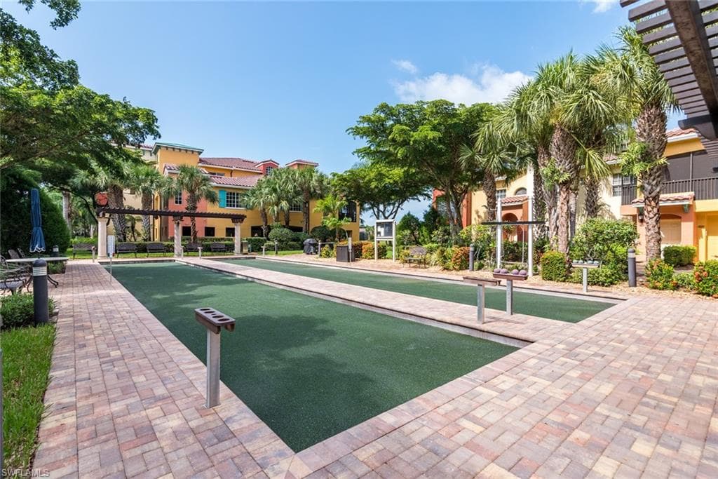 View of home's community featuring a bocce ball area and a pergola