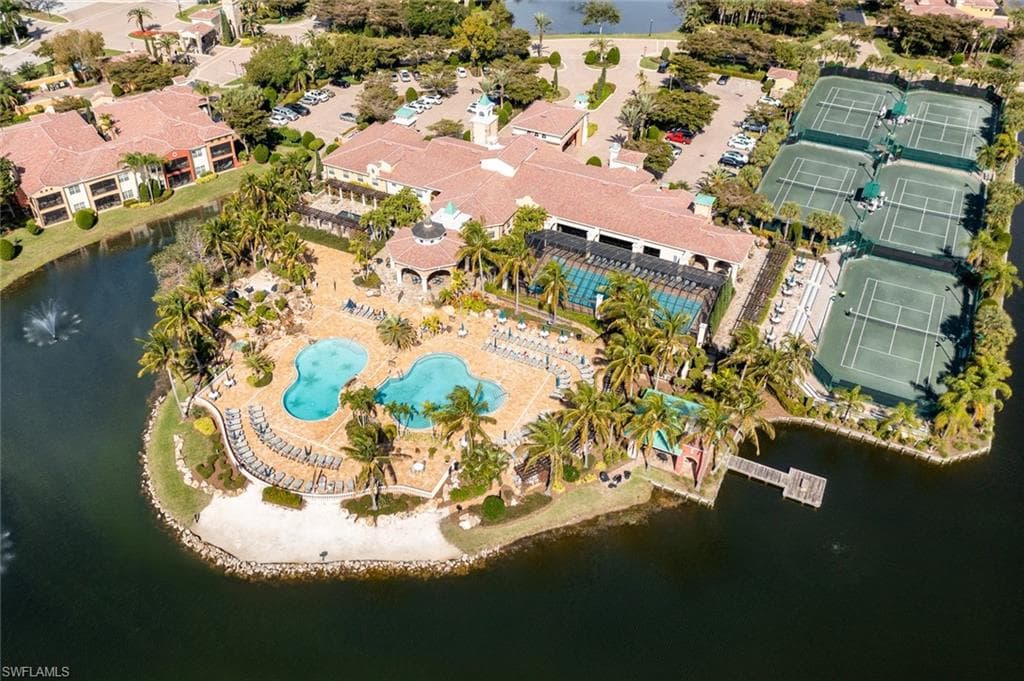 Bird's eye view of a nearby body of water and a pool area