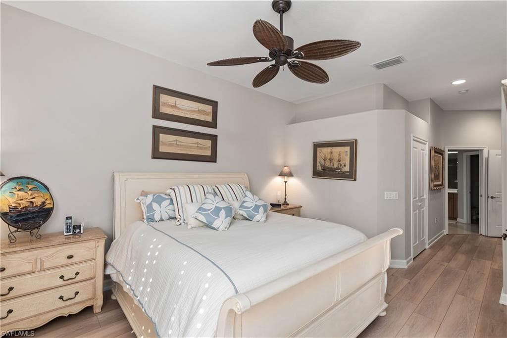 Bedroom with light wood-style floors, a closet, ceiling fan, and recessed lighting