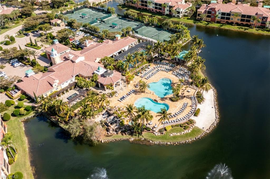 Drone / aerial view of a large body of water and a pool