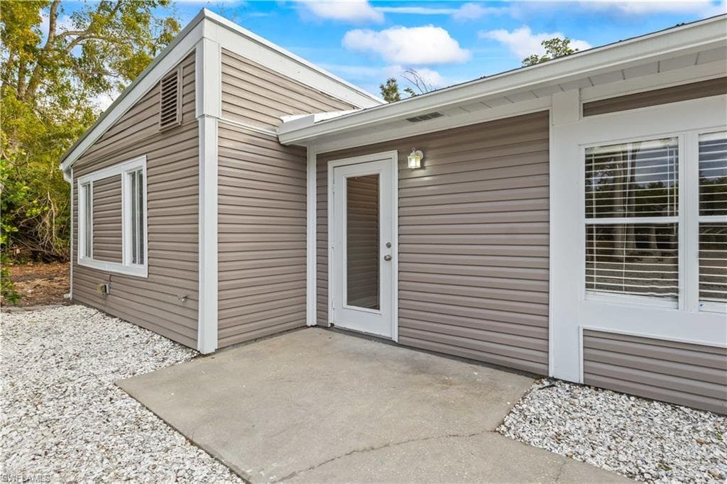A welcoming front entrance bathed in natural light, inviting guests to step inside.