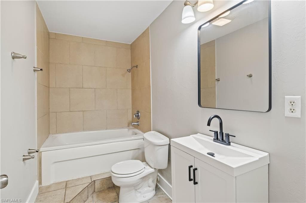 Clean and functional full bath conveniently located for guests and secondary bedrooms.