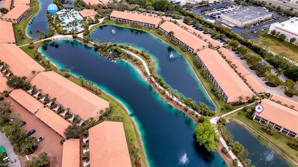 Bird's eye view of a nearby body of water and apartment complex / building