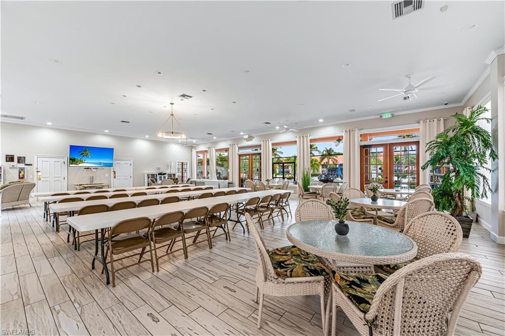 Dining space featuring wood tiled floors, recessed lighting, french doors, and crown molding