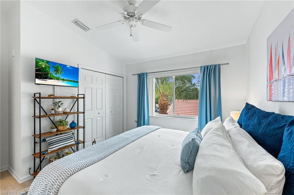 Bedroom featuring vaulted ceiling, a ceiling fan, a closet, and wood finished floors