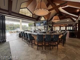 Bar area featuring high vaulted ceiling