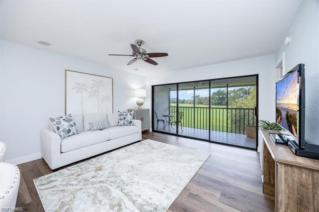Living area with wood finished floors and a ceiling fan