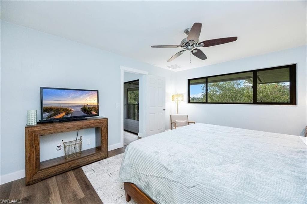 Bedroom with dark wood-type flooring and ceiling fan
