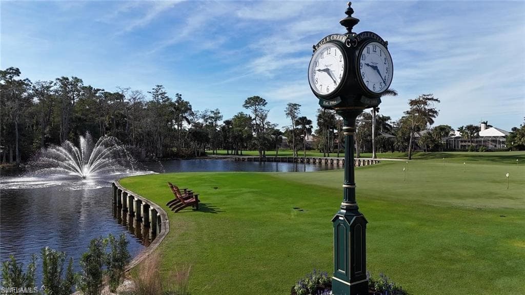 Surrounding community featuring a water view, golf course view, and a lawn