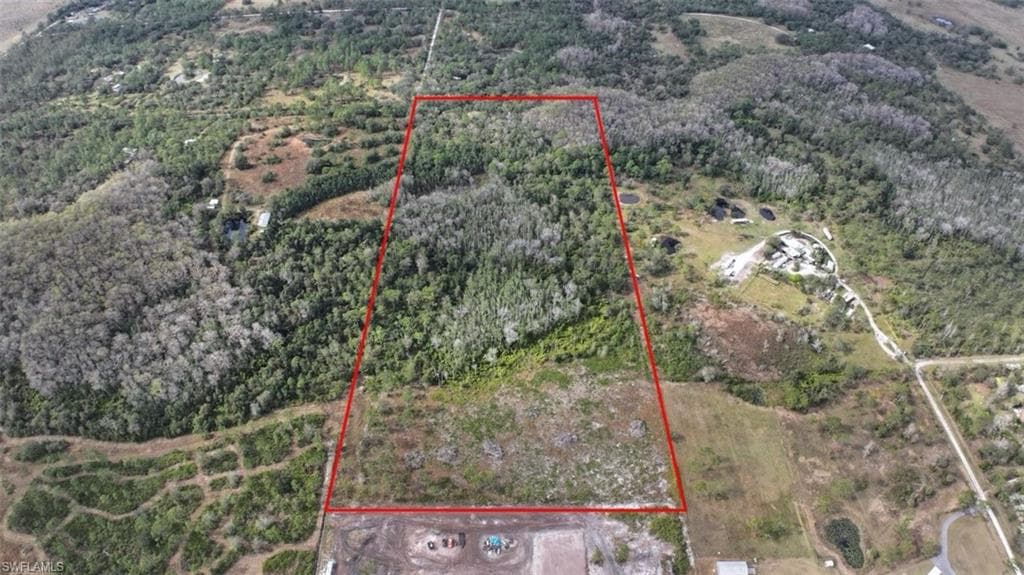 View of property location featuring property boundaries highlighted and a heavily wooded area
