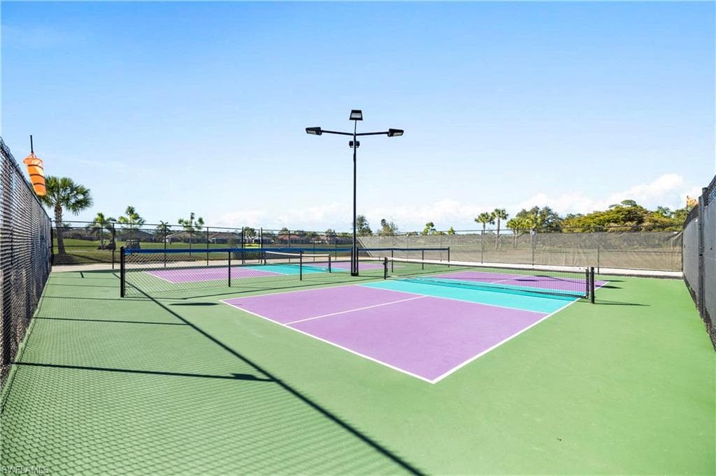 View of tennis court featuring community basketball court