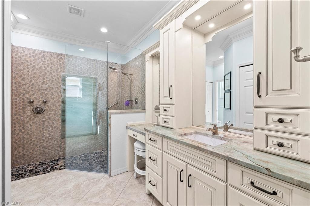 Full bathroom with ornamental molding, a walk in shower, vanity, recessed lighting, and light tile patterned flooring