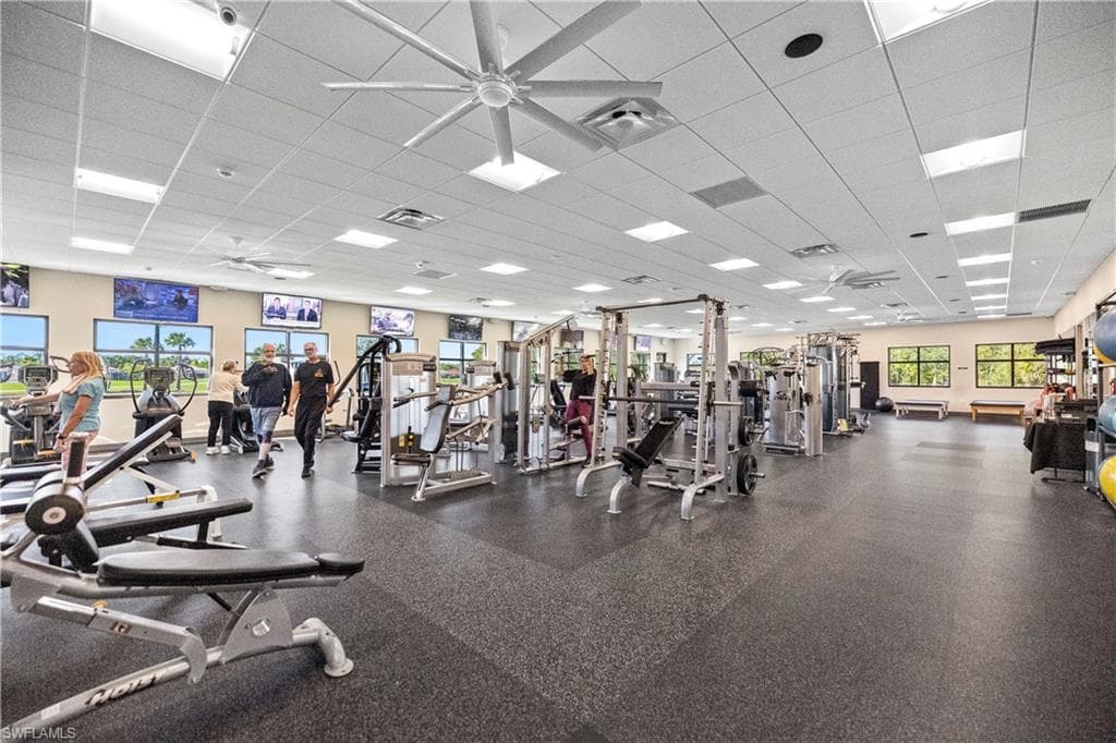 Gym featuring a drop ceiling and ceiling fan