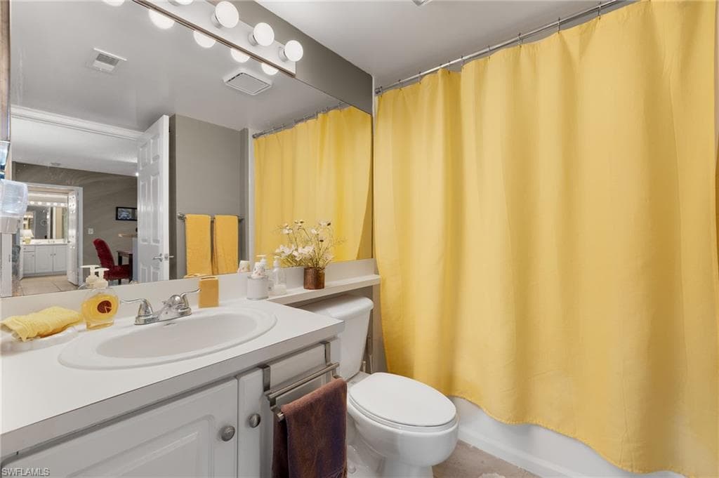 Bathroom featuring vanity and shower / tub combo
