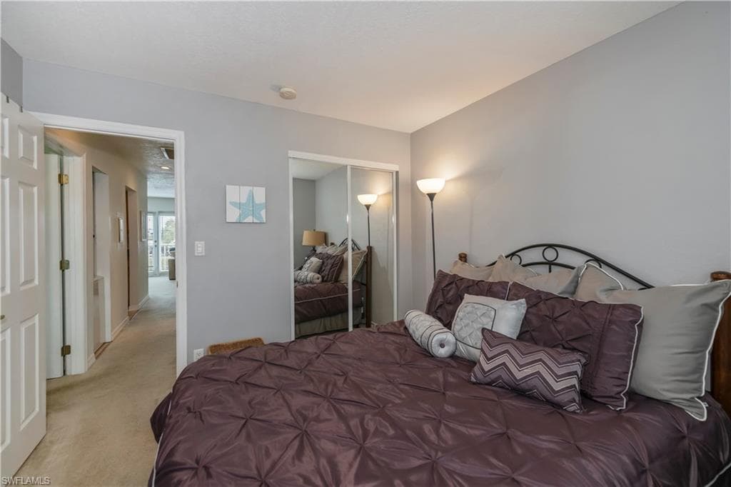Bedroom featuring a closet and light colored carpet