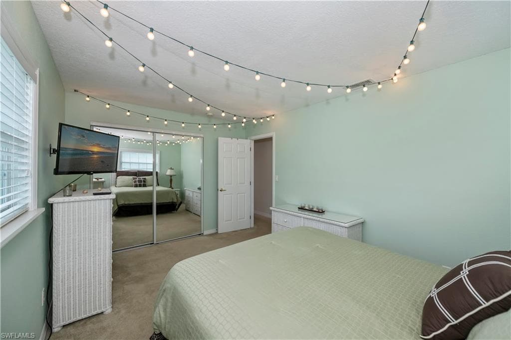 Bedroom with light colored carpet