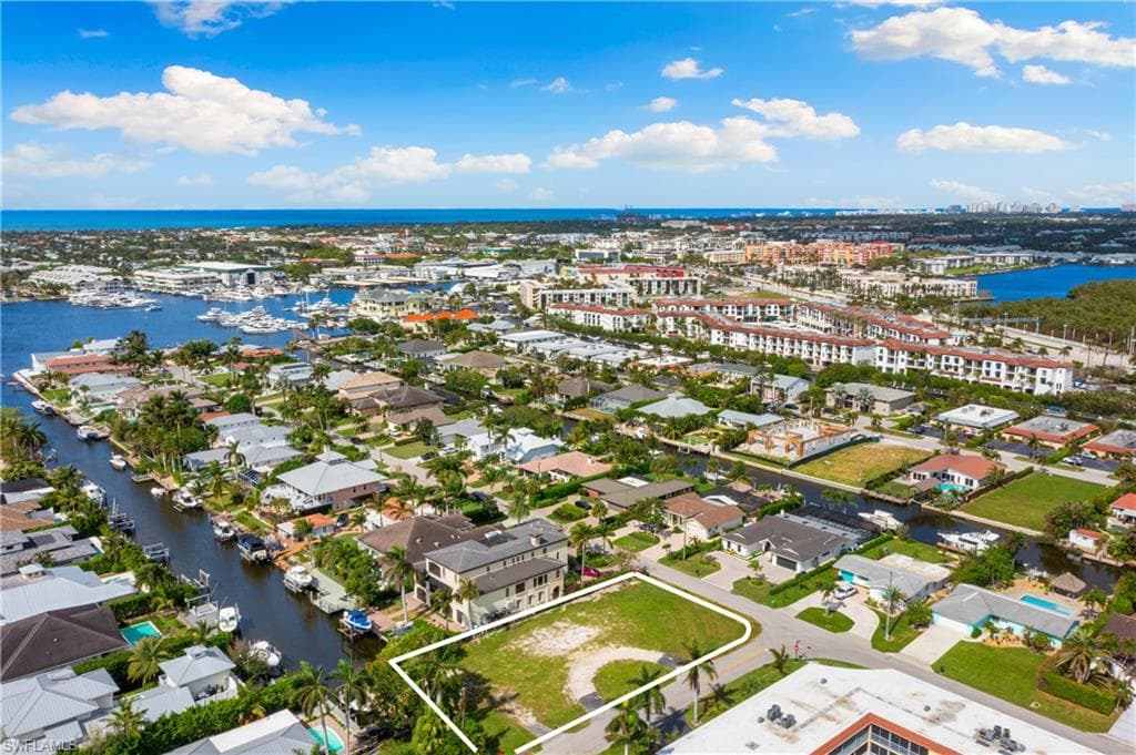 Aerial overview of property's location with a nearby body of water and property parcel outlined
