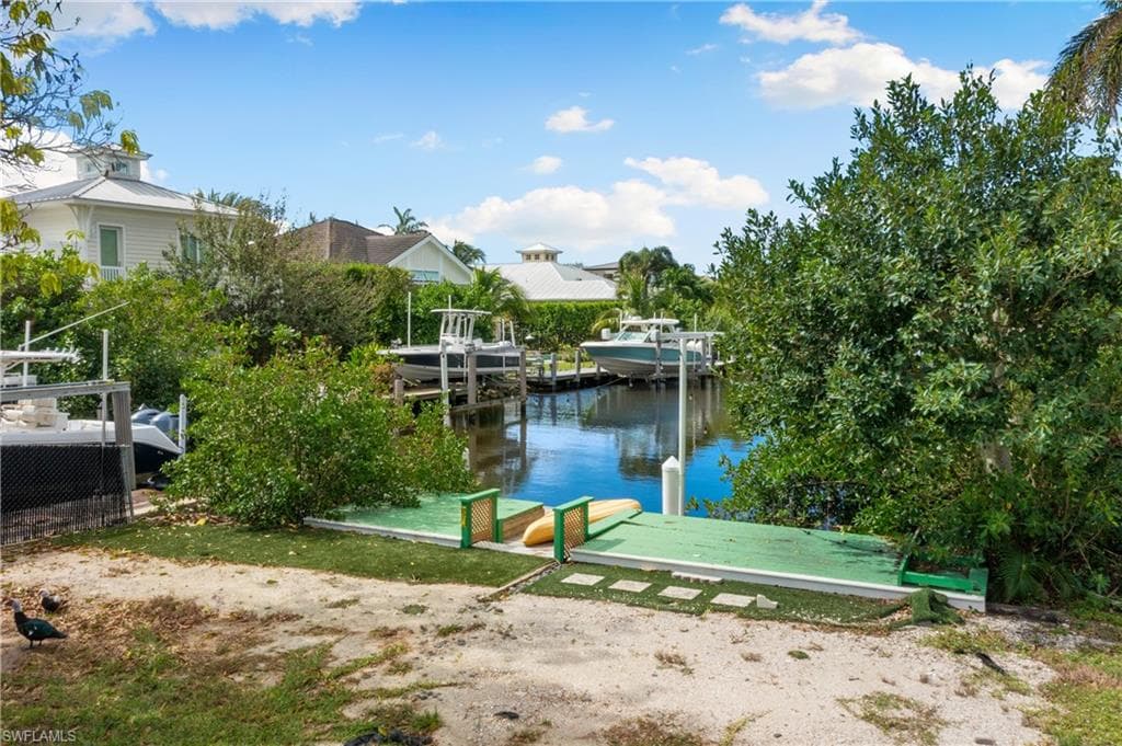Dock area featuring a water view and boat lift