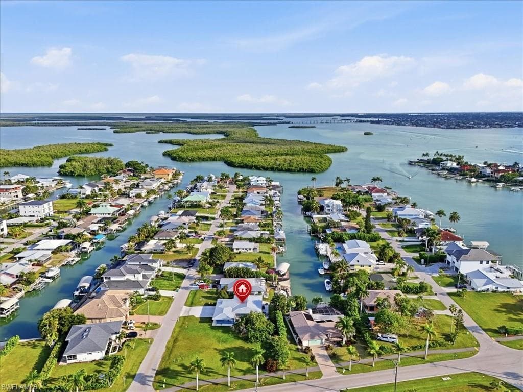 Aerial overview of property's location with nearby suburban area and a nearby body of water