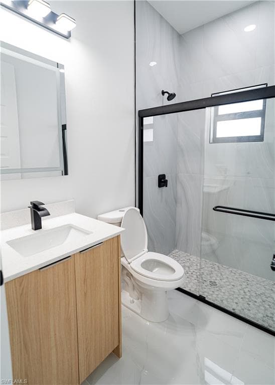 Bathroom with vanity and a stall shower