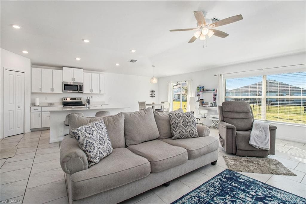 Living area featuring recessed lighting, ceiling fan, and light tile patterned flooring