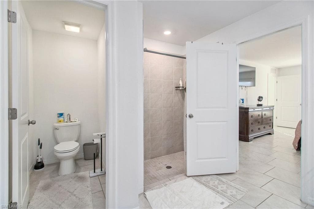 Bathroom featuring a stall shower and light tile patterned flooring