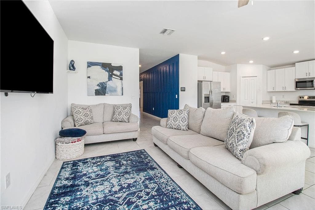 Living room featuring recessed lighting and light tile patterned floors