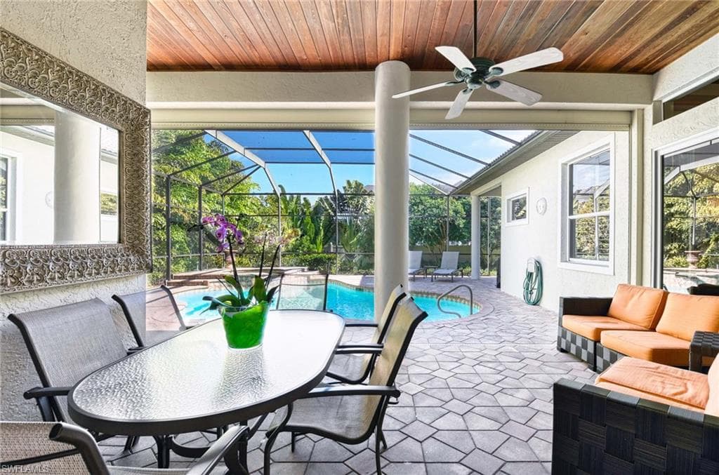 View of patio / terrace featuring ceiling fan, a sunroom, an outdoor pool, a lanai, and an outdoor hangout area