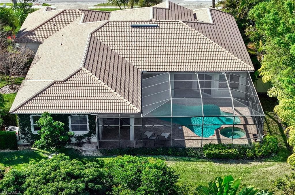Aerial view of property and surrounding area featuring a pool