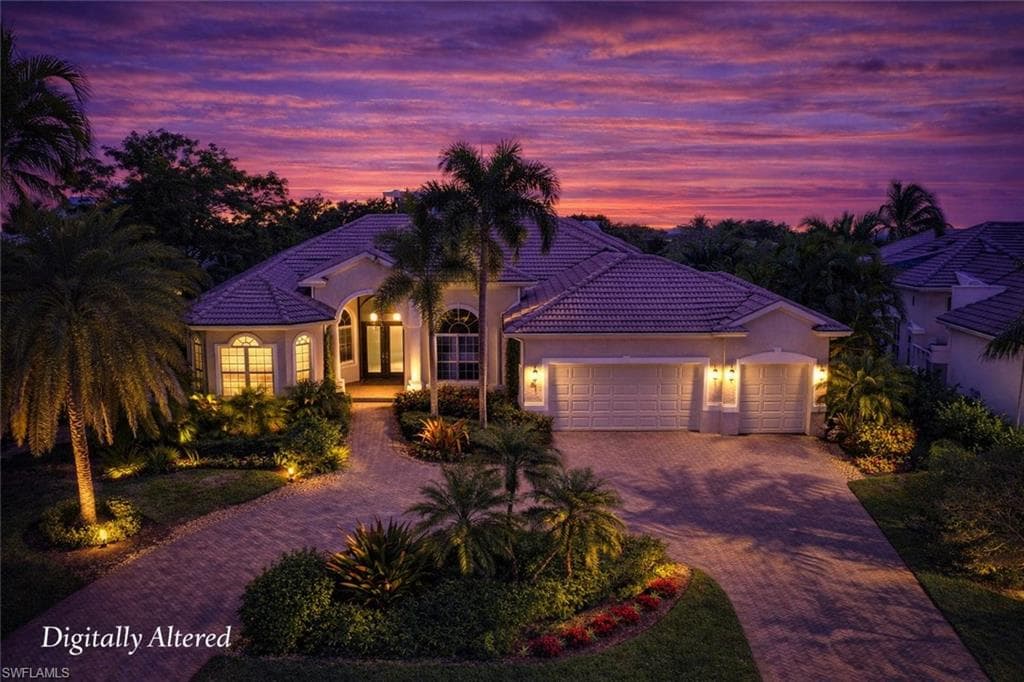Mediterranean / spanish home featuring a garage, stucco siding, decorative driveway, and a tiled roof