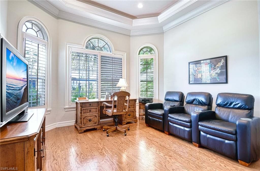 Home office with light wood-style flooring and ornamental molding