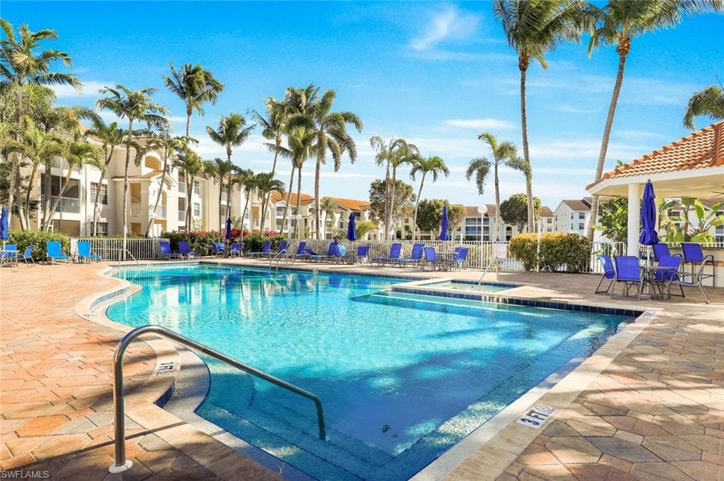 Community pool with a hot tub and pool bar for entertaining