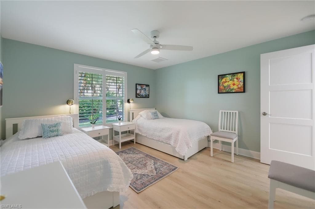 Bedroom with light wood-style floors and ceiling fan