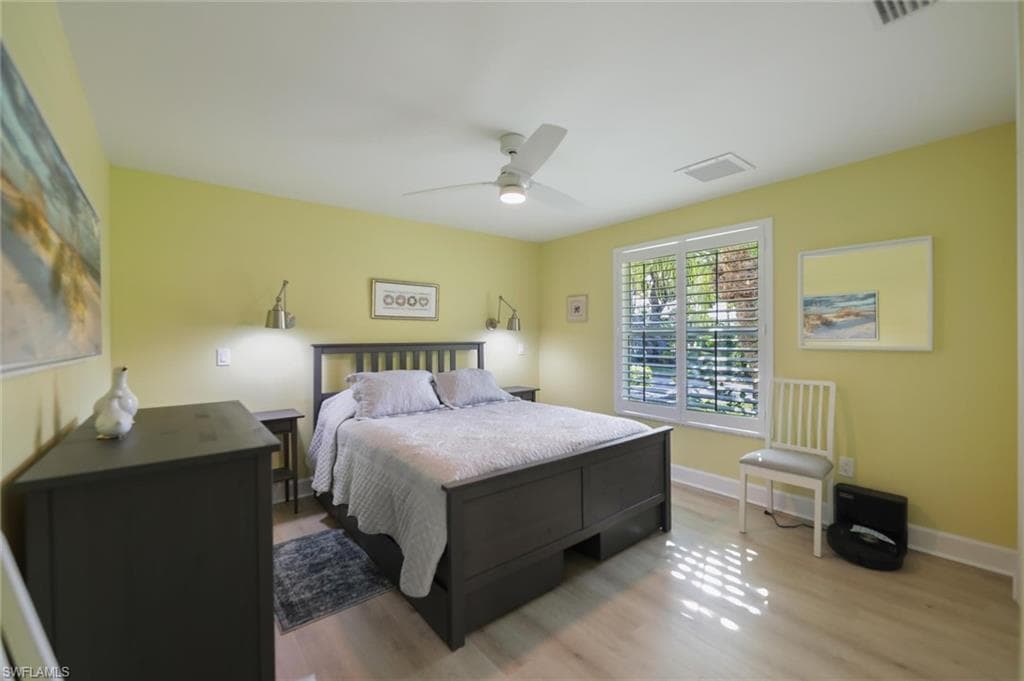 Bedroom with wood finished floors and a ceiling fan