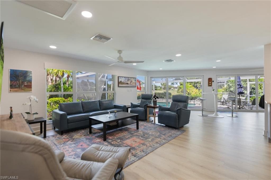 Living room featuring wood finished floors, recessed lighting, and ceiling fan